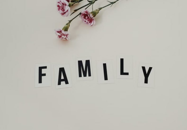 Elegant arrangement of pink flowers and family text on a white background, ideal for family themes.